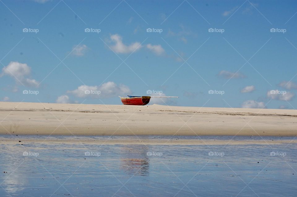 Red fisher boat in the beach 