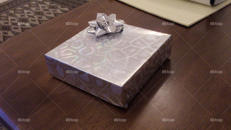 A gift. Sweets wrapped up in a pretty silver wrapping