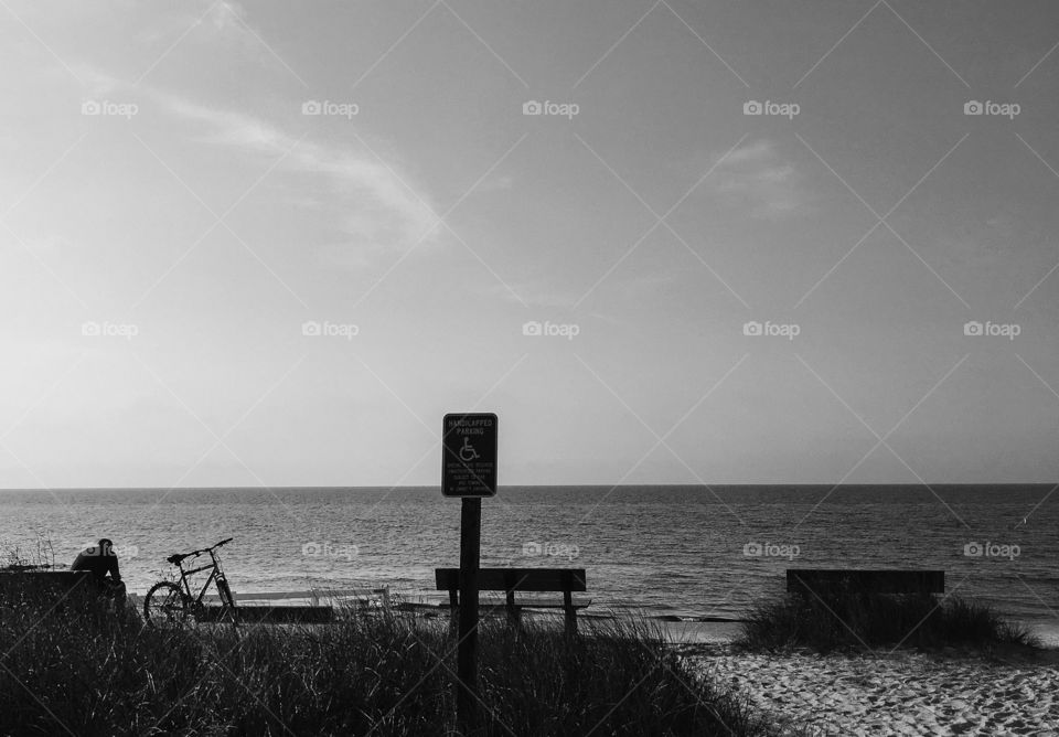 Early morning contemplation - this man was sitting on a bench watching the ocean.  His bike is next to him and the beach is quiet. 