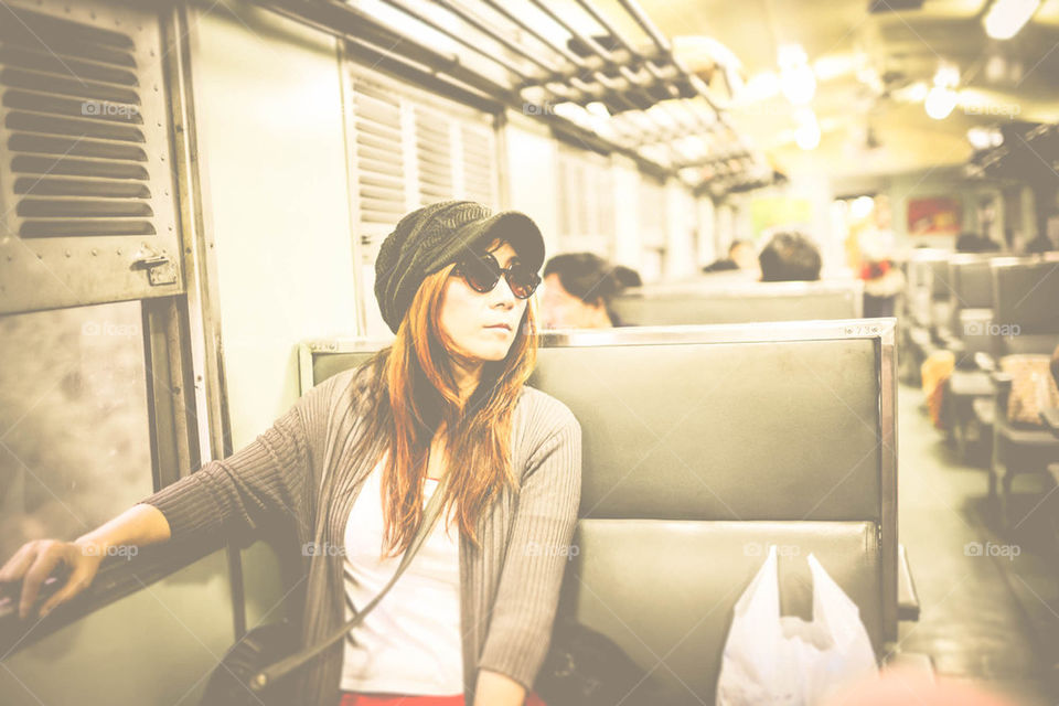 Asian woman travelling on train.