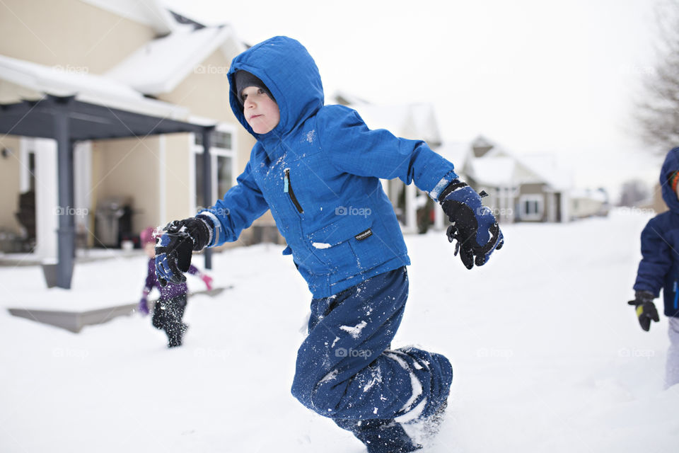 Boy running in the snow 