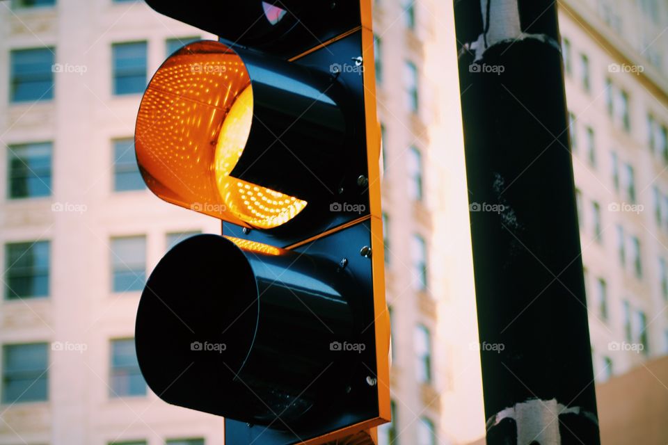 Yellow light at crossing in city 