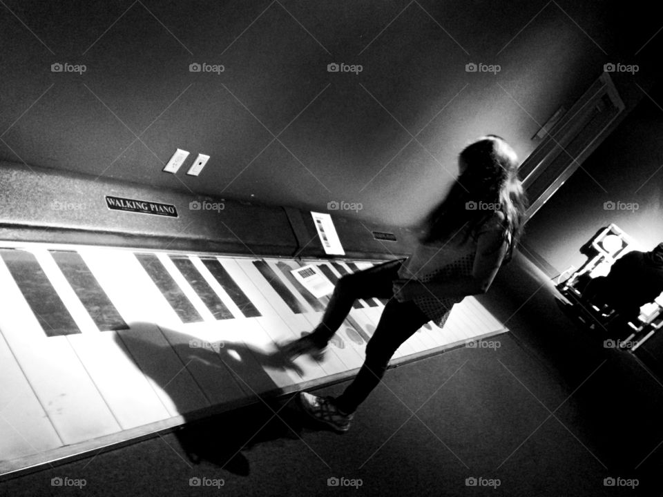 Girl playing Walking Piano. 9 year old girl playing walking piano at Vancouver Science Centre