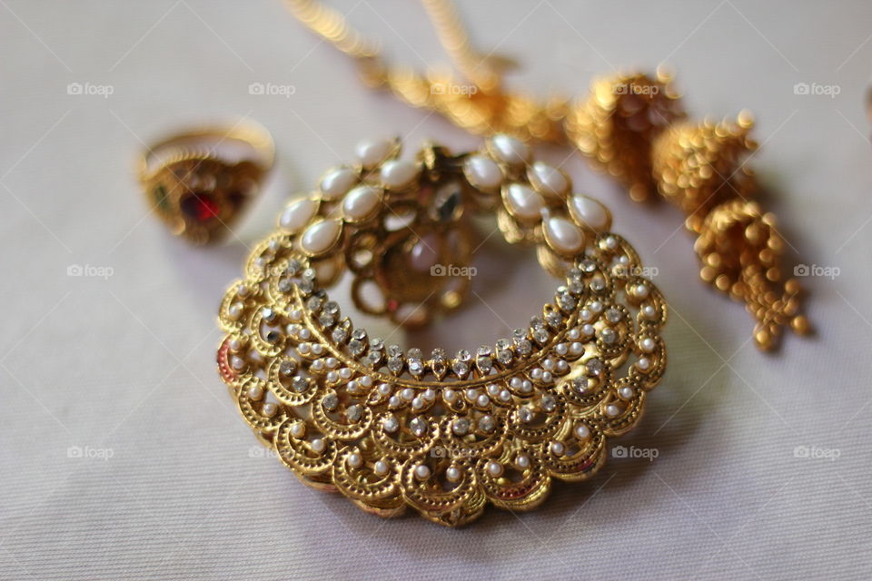 Gold and pearl jewelleries in indoors