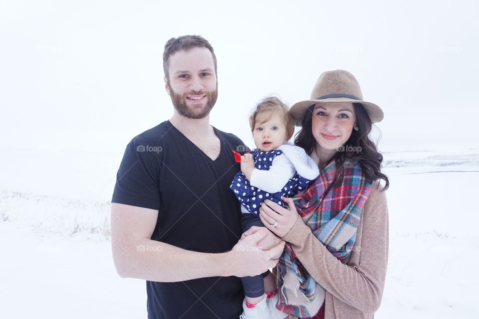 Portrait of happy family standing in snowy weather