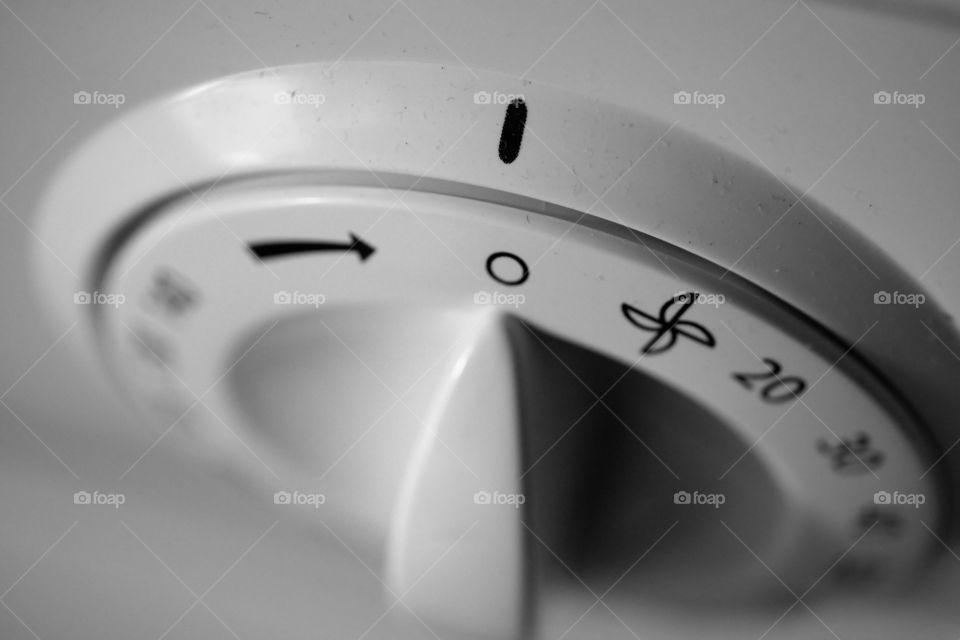 Spin dry 
a black and white close up of a tumble dryer knob or selection wheel