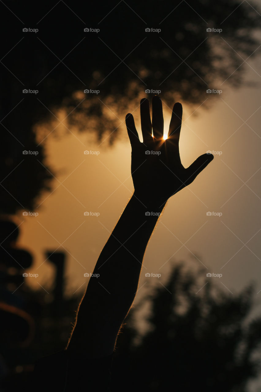 Hand silhouette against the sun 