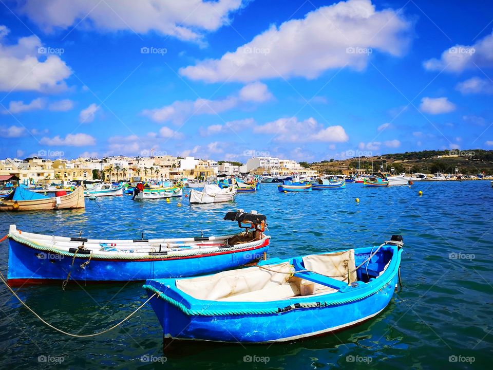 Blue boats in the blue sea of ​​Malta