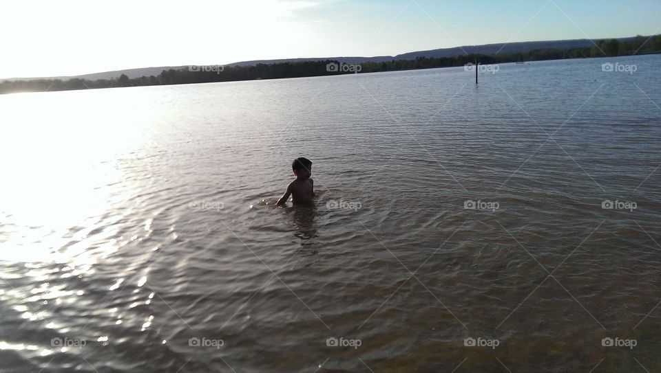 swimming in the river . my son swimming in the river 