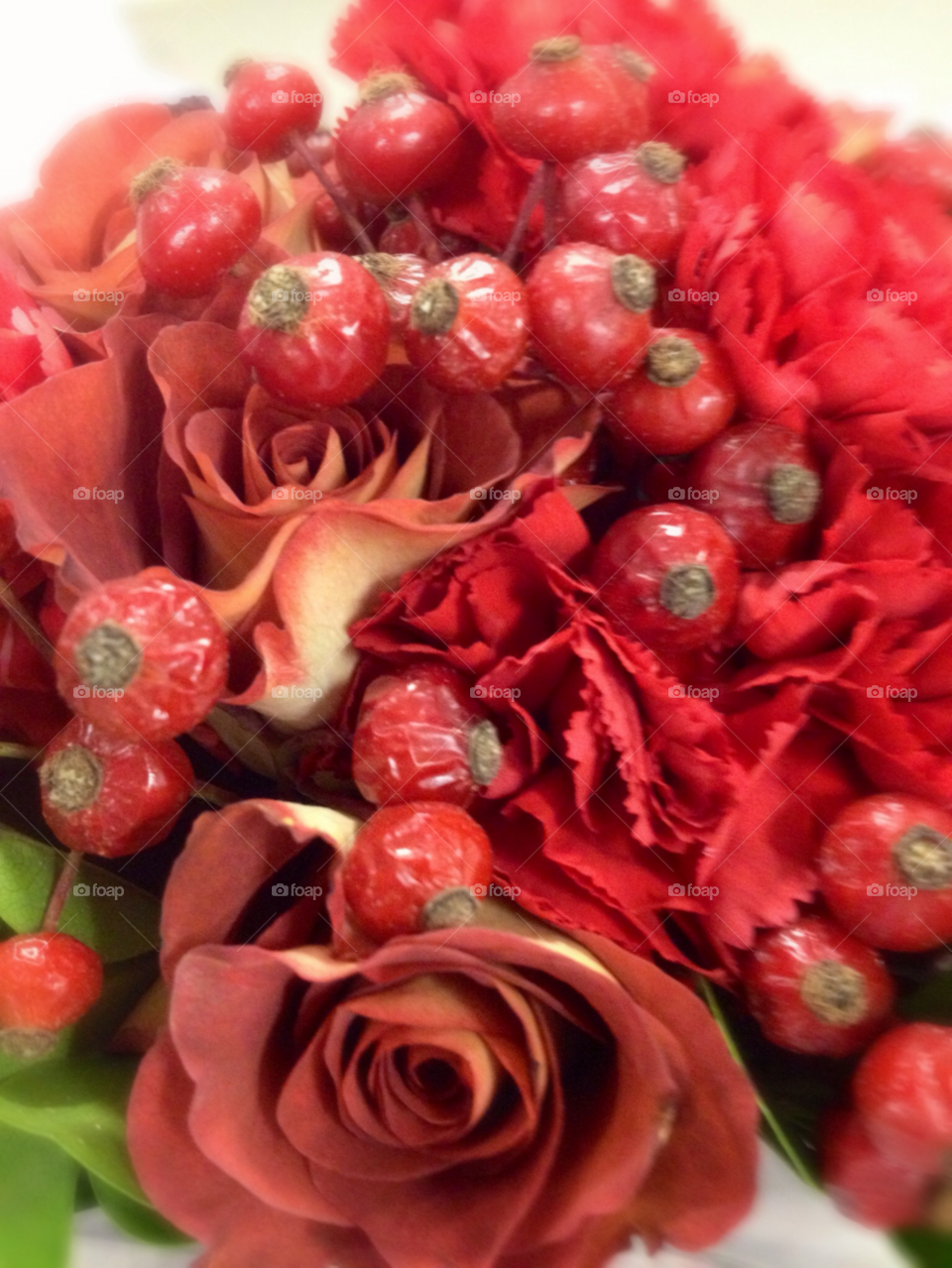 red berries red roses red carnations holiday bouquet by eastofsheridan