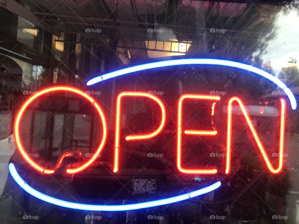 A neon orange open sign