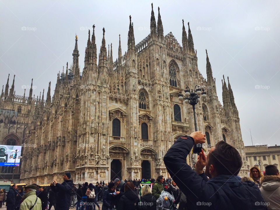 A photographer takes a photo of the Duomo of Milan,Italy