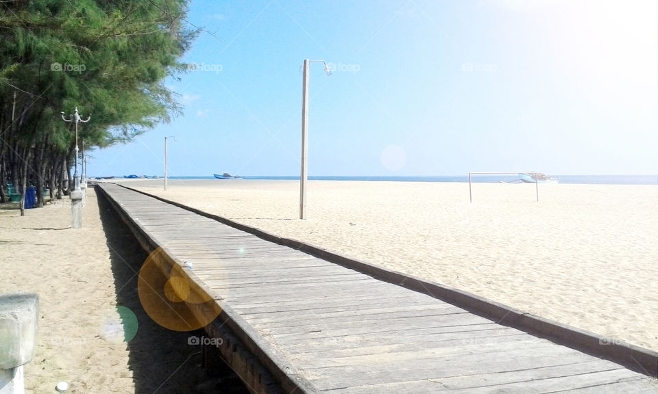 isolated calming sidewalk in a sunny beach on a sunny day