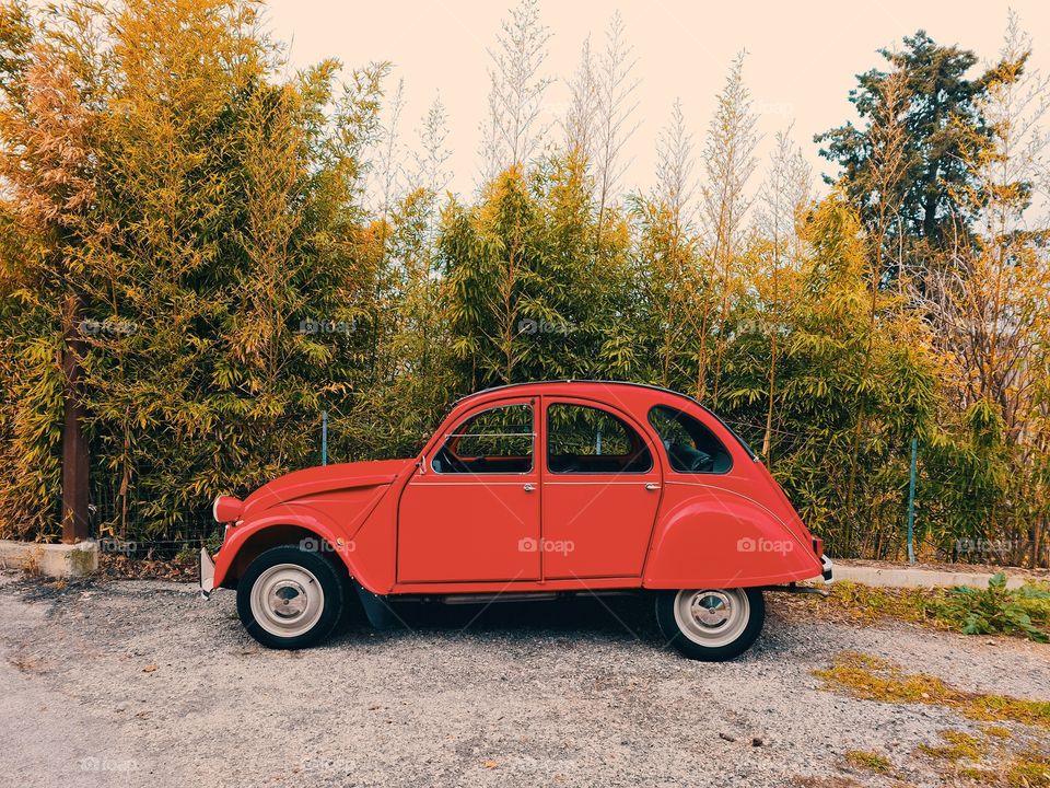 red vintage car with rounded lines