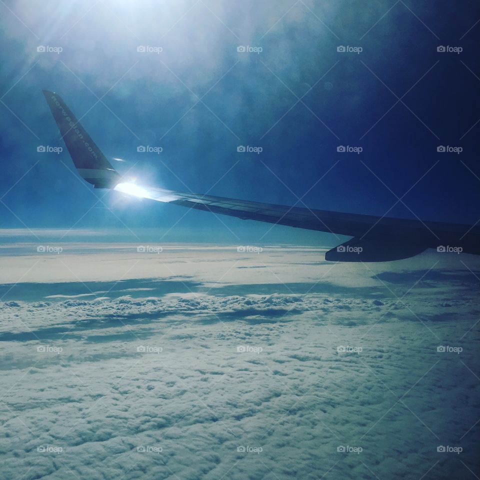 Airplane window. Travel, sun, plane, window, sky, sun,  clouds, summer, travel, city break, city, aeroplane, sky travel, wing, air, sky, flying, fly.