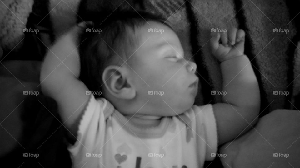 Elevated view of a baby sleeping on bed
