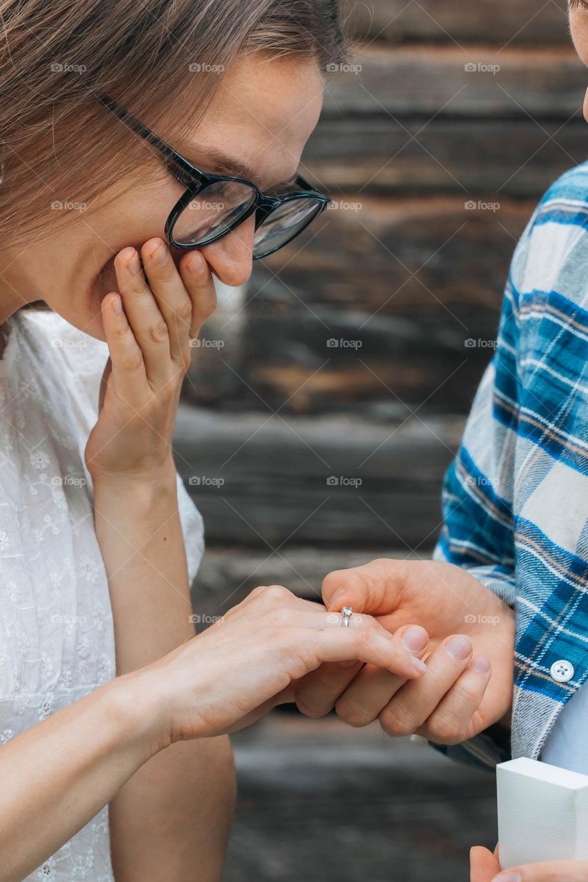 Surprised woman getting marriage proposal 