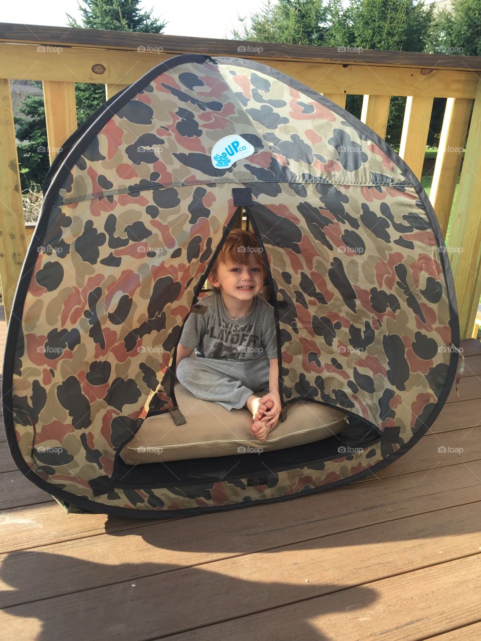 Boy sitting in tent house