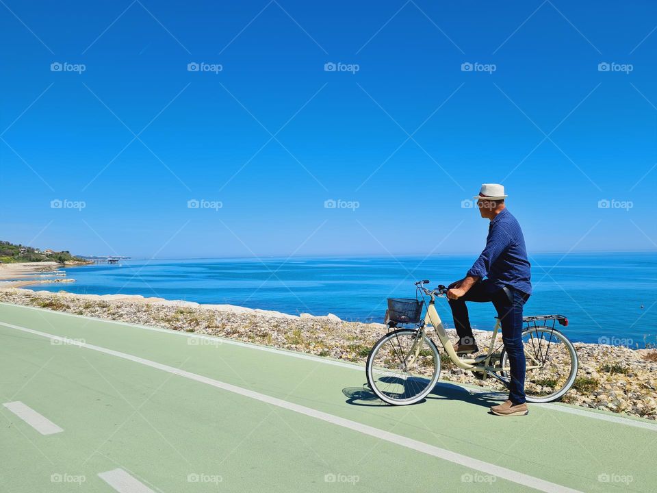 man on a bike on the wonderful cycle path on the sea of ​​the "Costa dei Trabocchi" in Italy