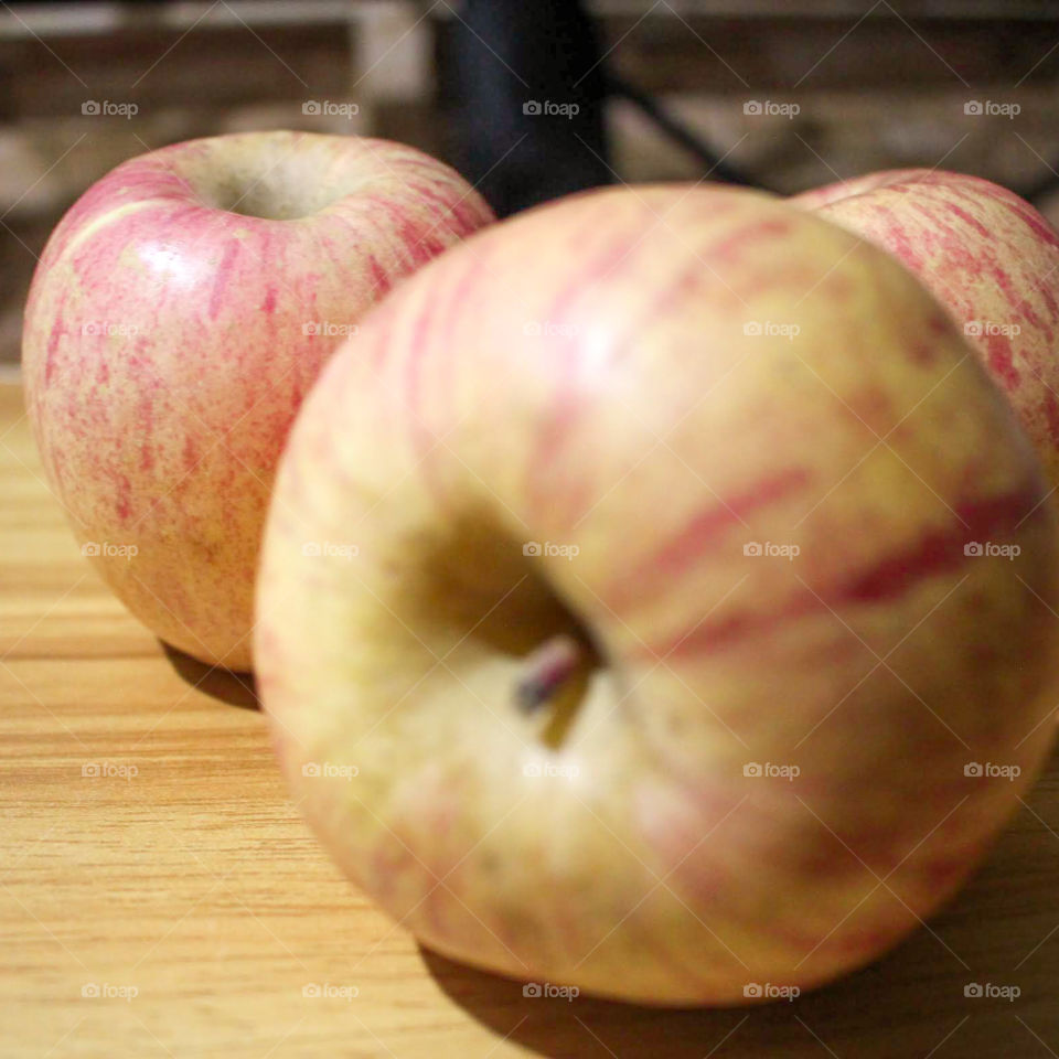 three apples on a table