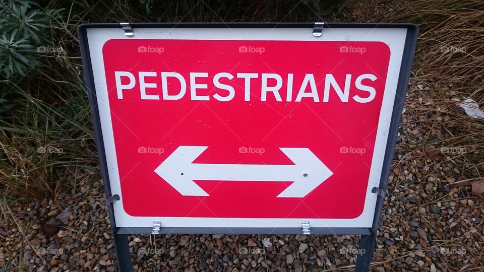 Sign instructing pedestrians to walk around pavement works on Snowsfiejds, near Guy’s Hosptial, London. Passed en route to work in Spring.