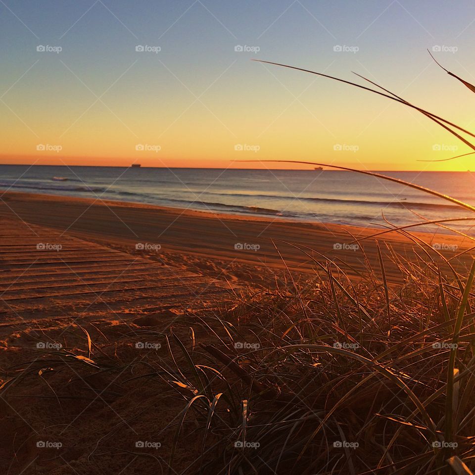 Orange beach sunrise over the sand 