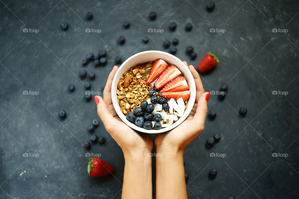 breakfast smoothie bowl in woman's hands