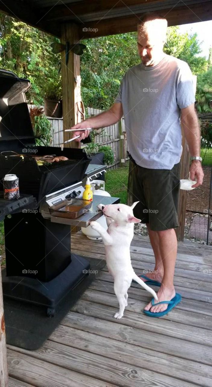 Little guy wants to help Dad cook on the grill