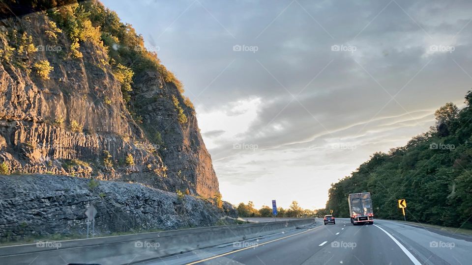 Beautiful Rocky smoky mountains in Tennessee on the road driving to n the highway with other travelers at sunset right by the road on vacation this impressive view scenery on a cloudy day at sunset.