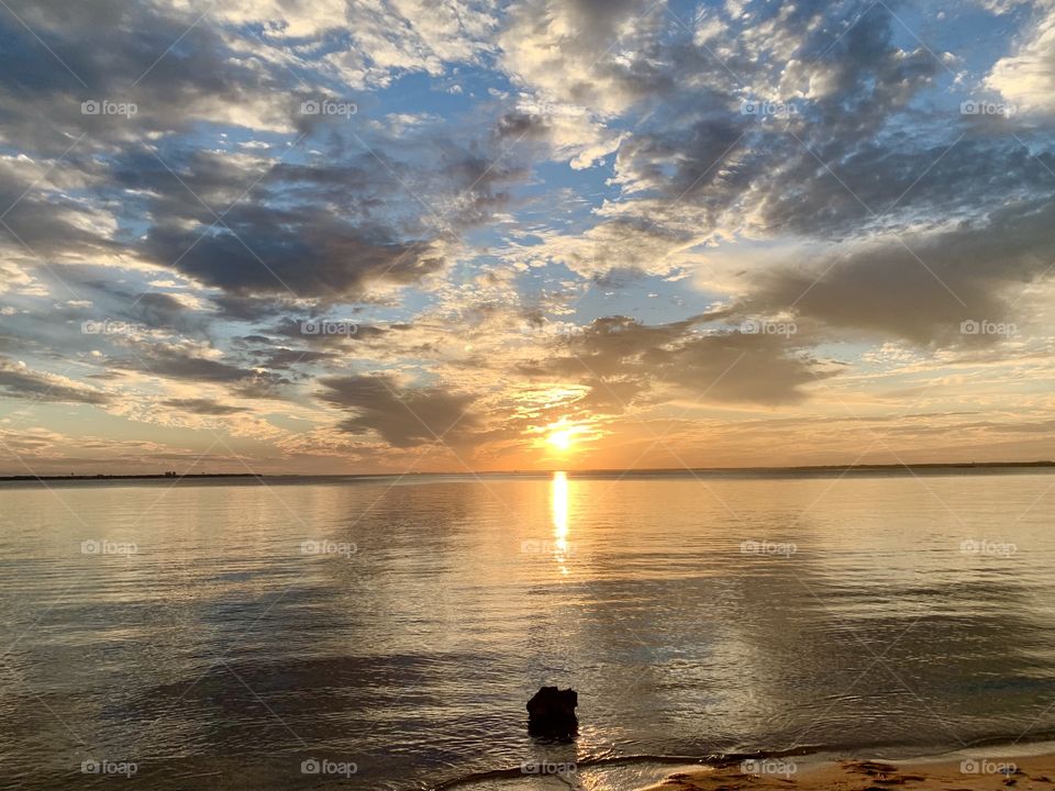 The yellow ball of fire changed to hues of orange, blue, and then tangerine. It merged with the sky. The clouds were like cotton-candy, as though they blushed at the warm touch of the sun