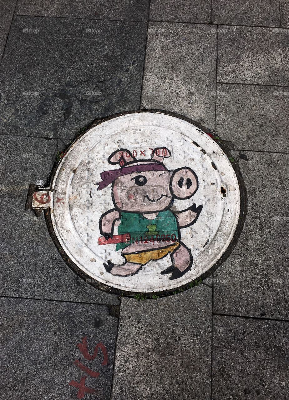 Graffiti Street Art on Manhole Cover in Dafen Oil Painting Village - Shenzhen, China