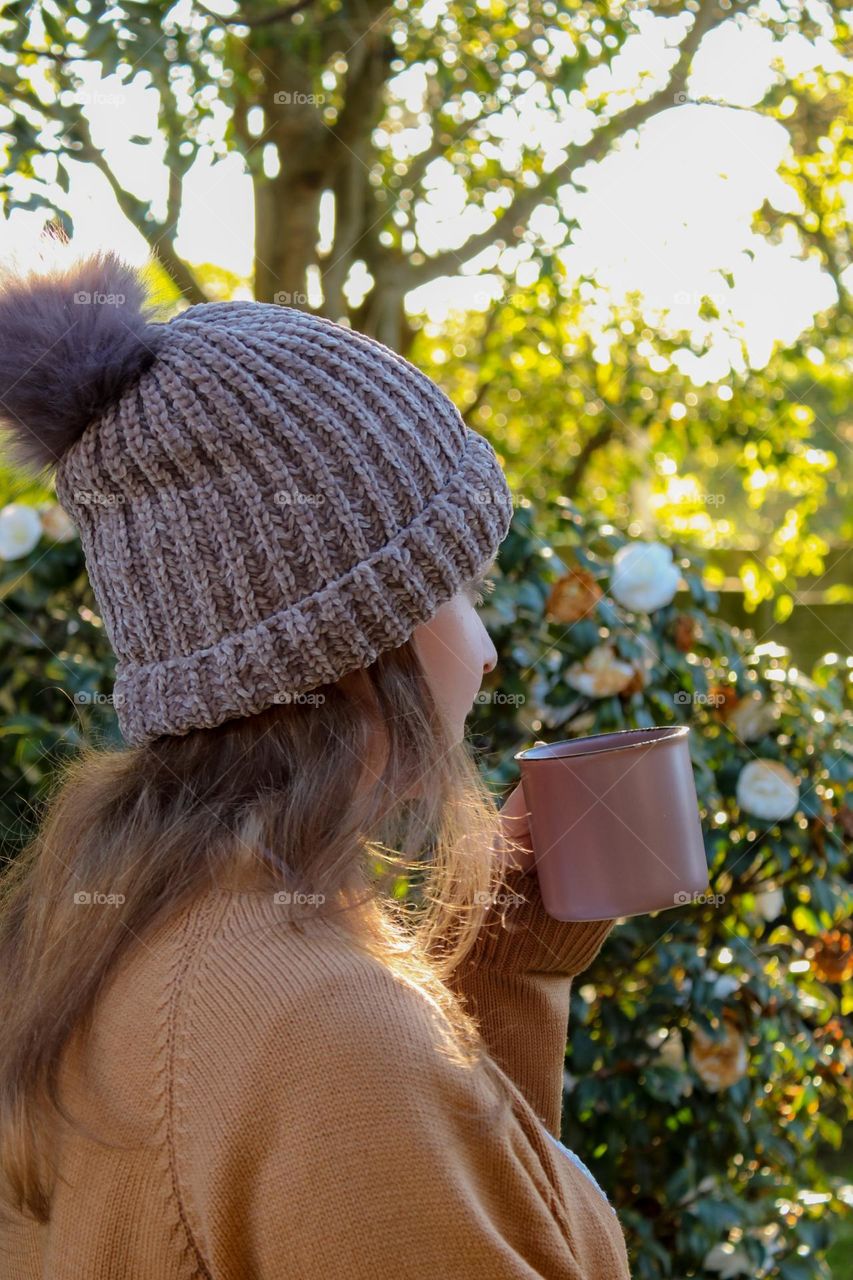 A woman drinking coffee outside