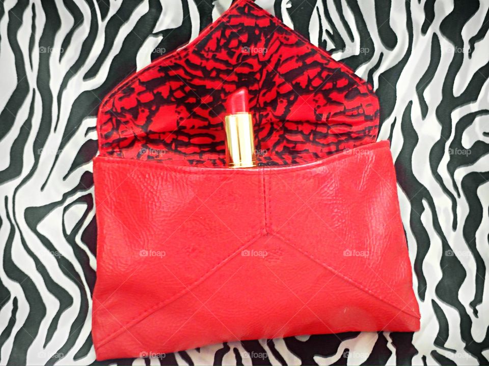 Red lipstick in red bag 