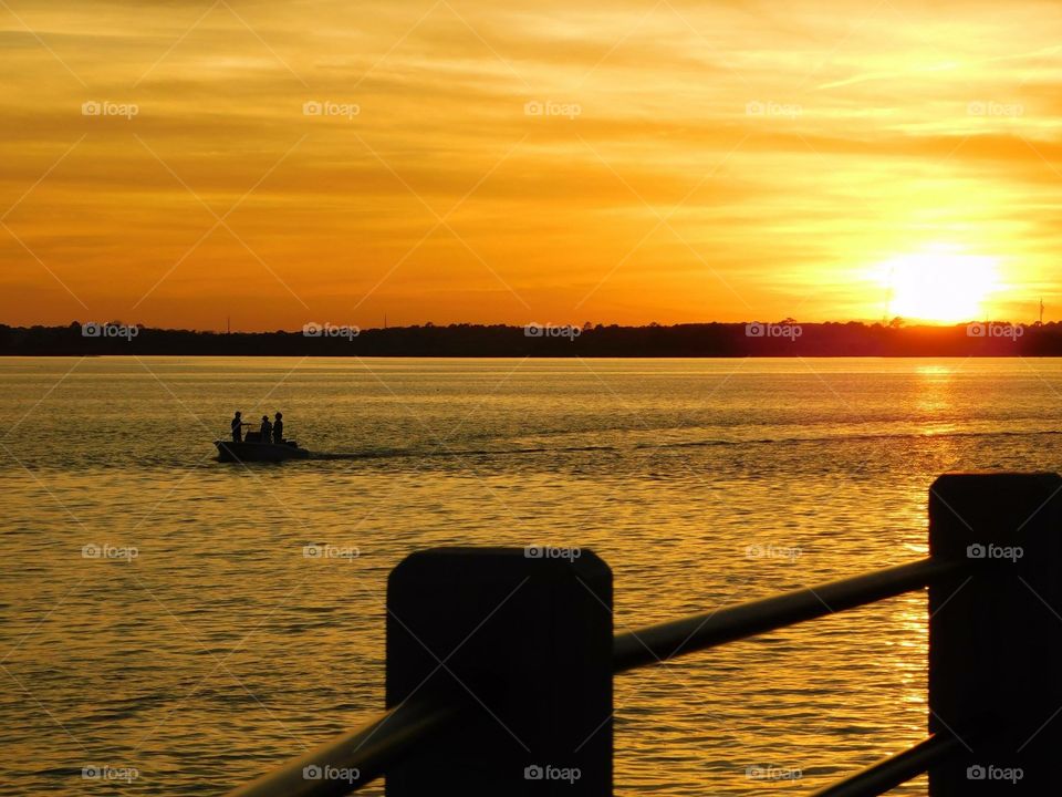 Sunset over the Battery in downtown Charleston, SC.
The guys on that boat were blasting their music and having a grand loud time as they floated on. :-) 