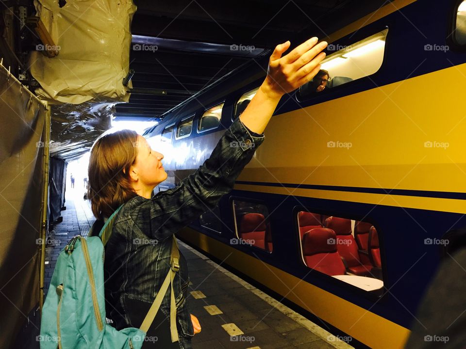 Woman saying goodbye to train