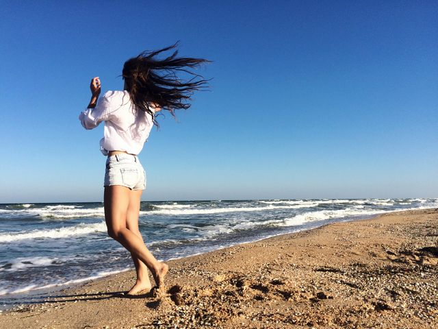 Young woman walking on beach