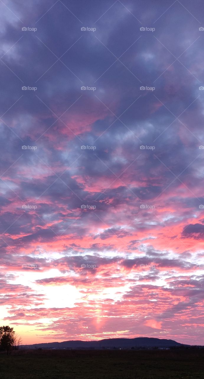 A purple clouds in sky during a sunset.