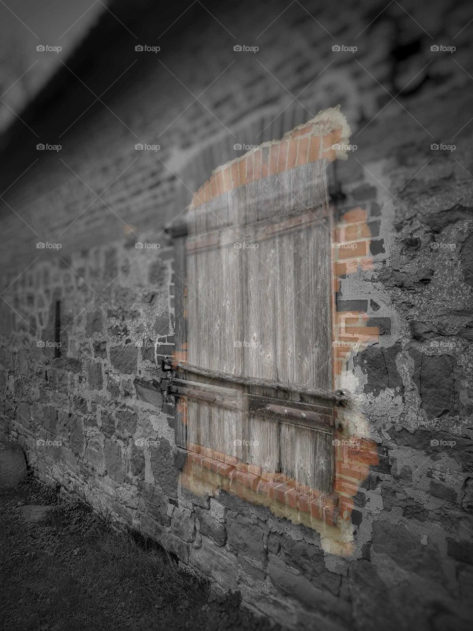 Old wooden Window in b/w Sandstone Wall