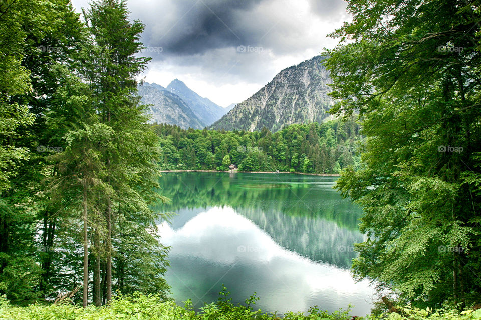 Reflection of trees and mountain on lake