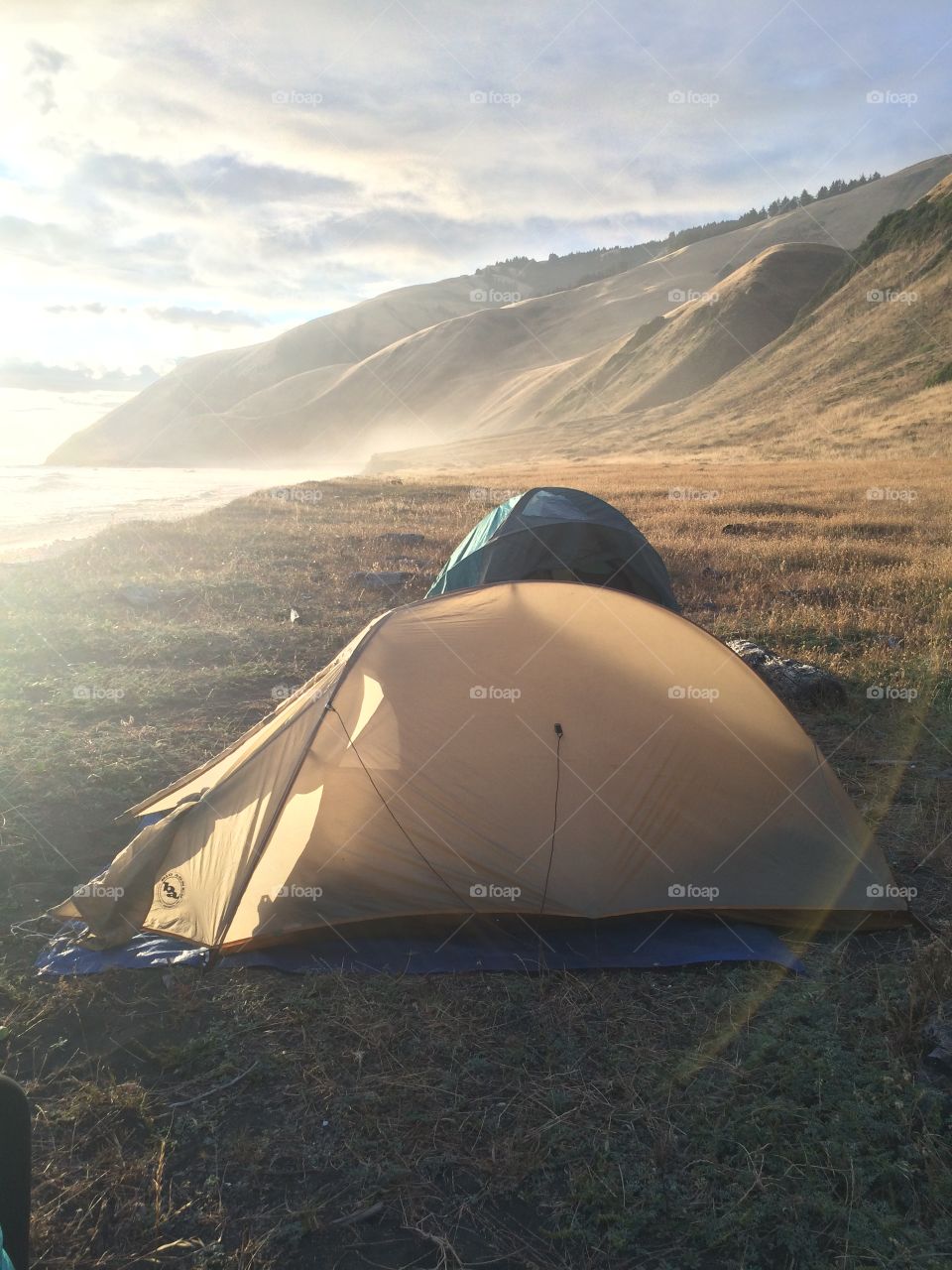 Two tents on the lost coast trail in Northern California at the oceans edge