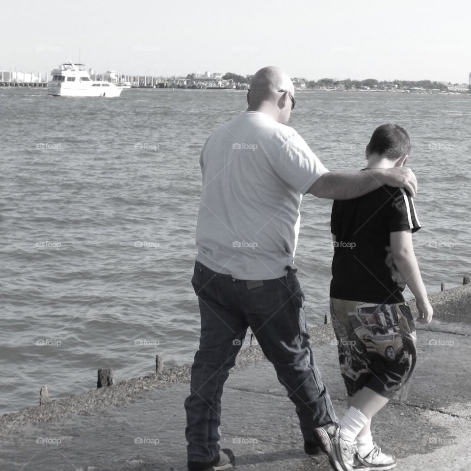 My husband and son walking to gather in Galveston Texas. In black and white