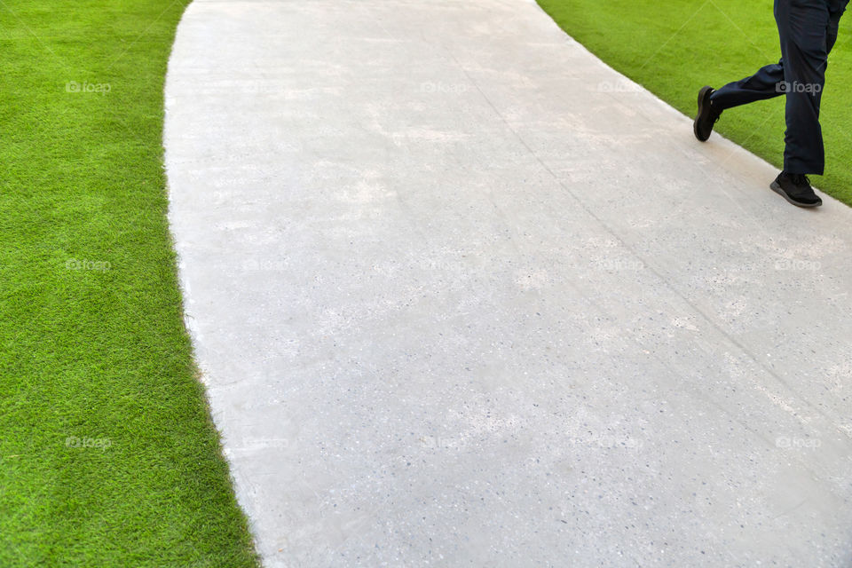 Abstract minimalism, road and grass, man walking by