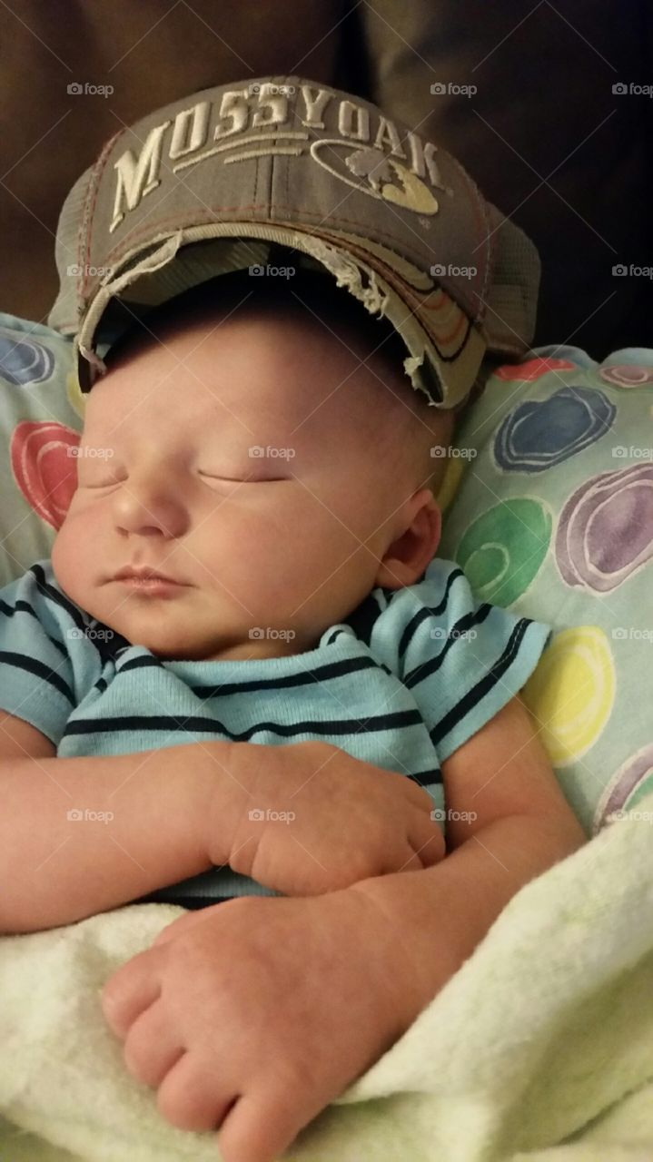 Asleep with daddy’s hat on