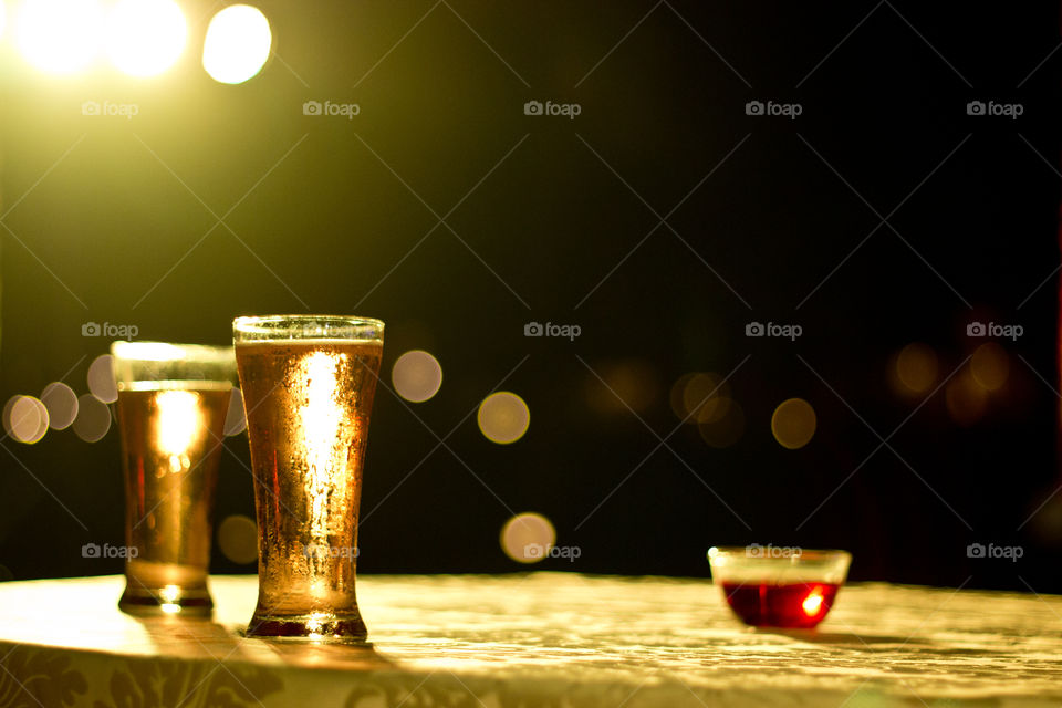 Focus of light on glass of soft drink on a party table