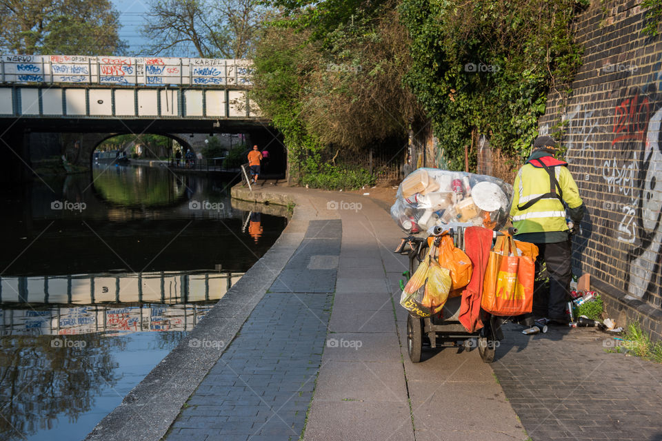 Man working with removing the wekeend tradh from the streets near Camden Market in London.