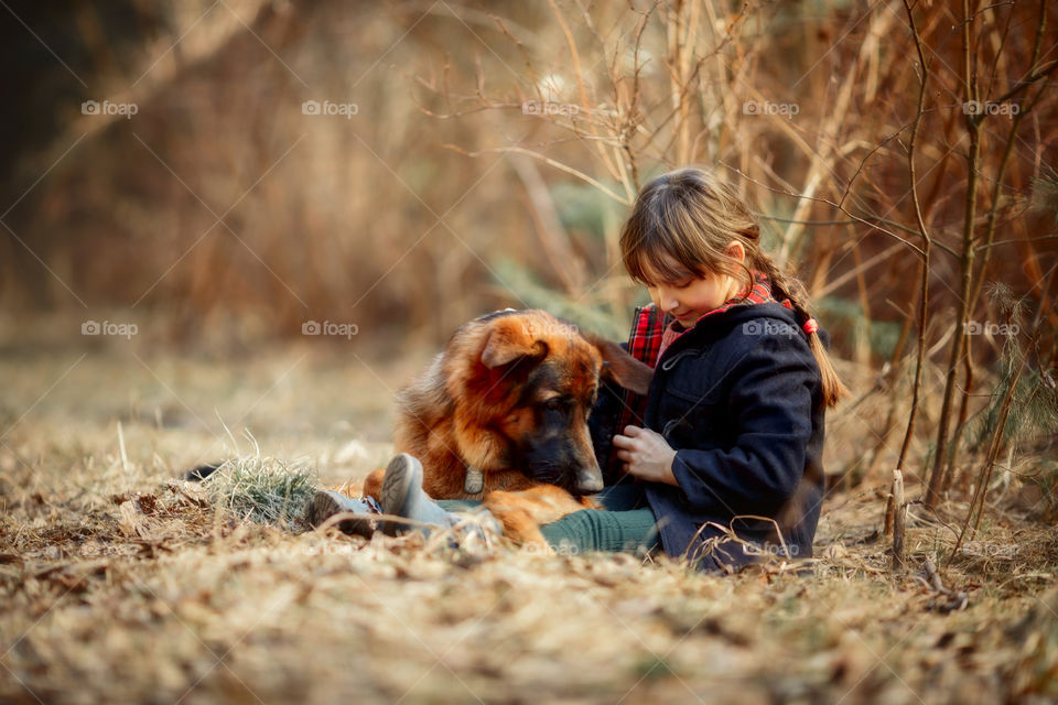 German shepherd dog and little girl portrait in spring park