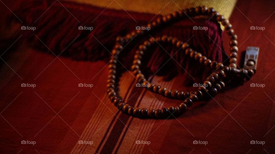 Wooden prayer beads on a prayer mat