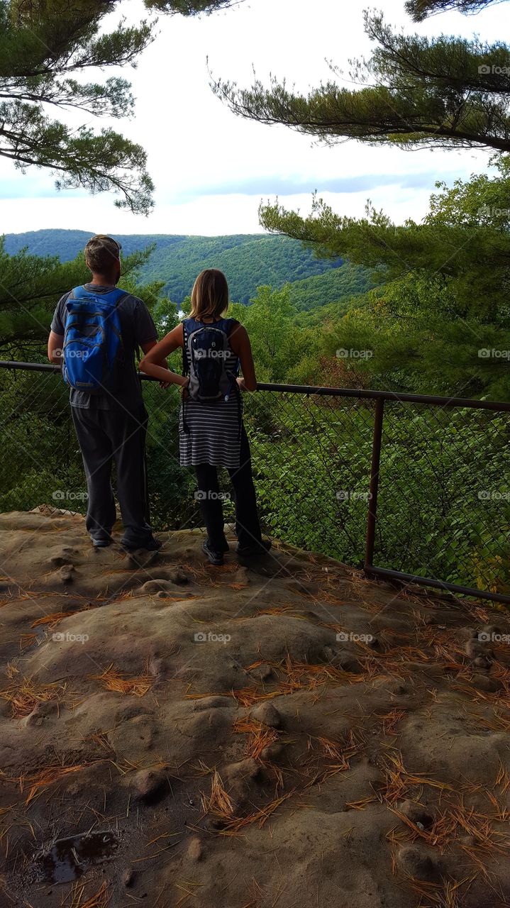 Hikers take in the view once the reach the overlook and pause to reflect on the view.