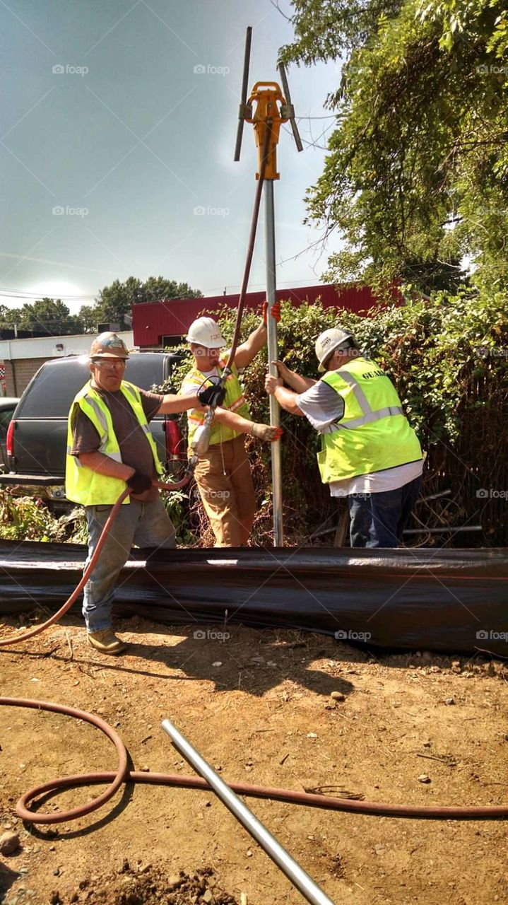 fence work. pounding post in the ground for a fence