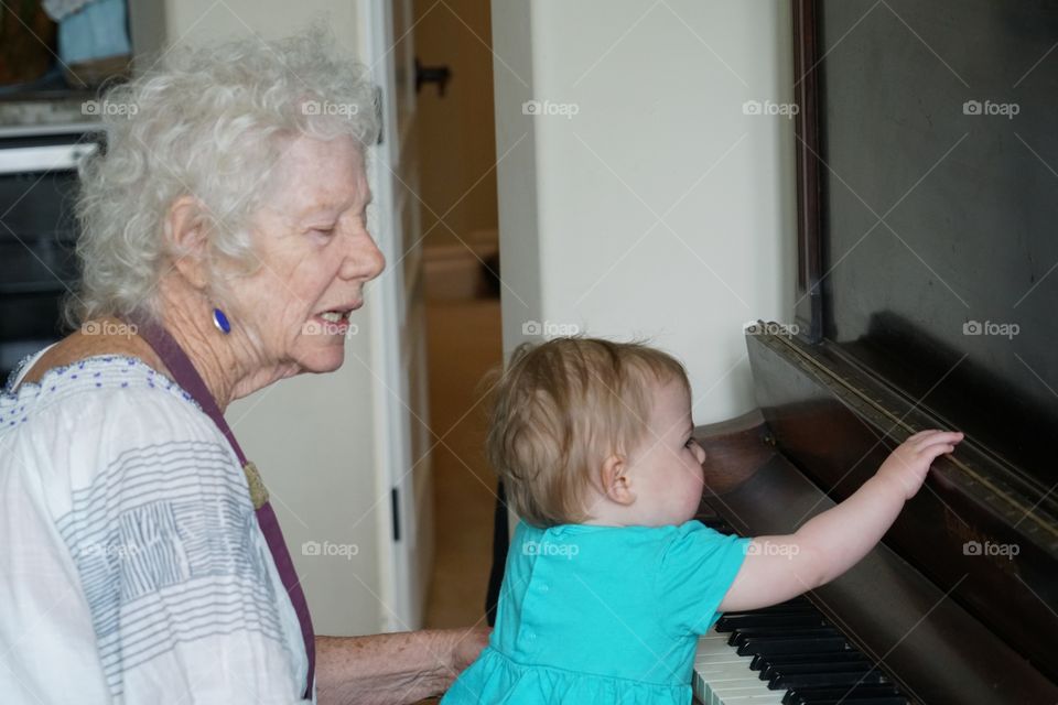 Grandmother And Baby Playing Piano